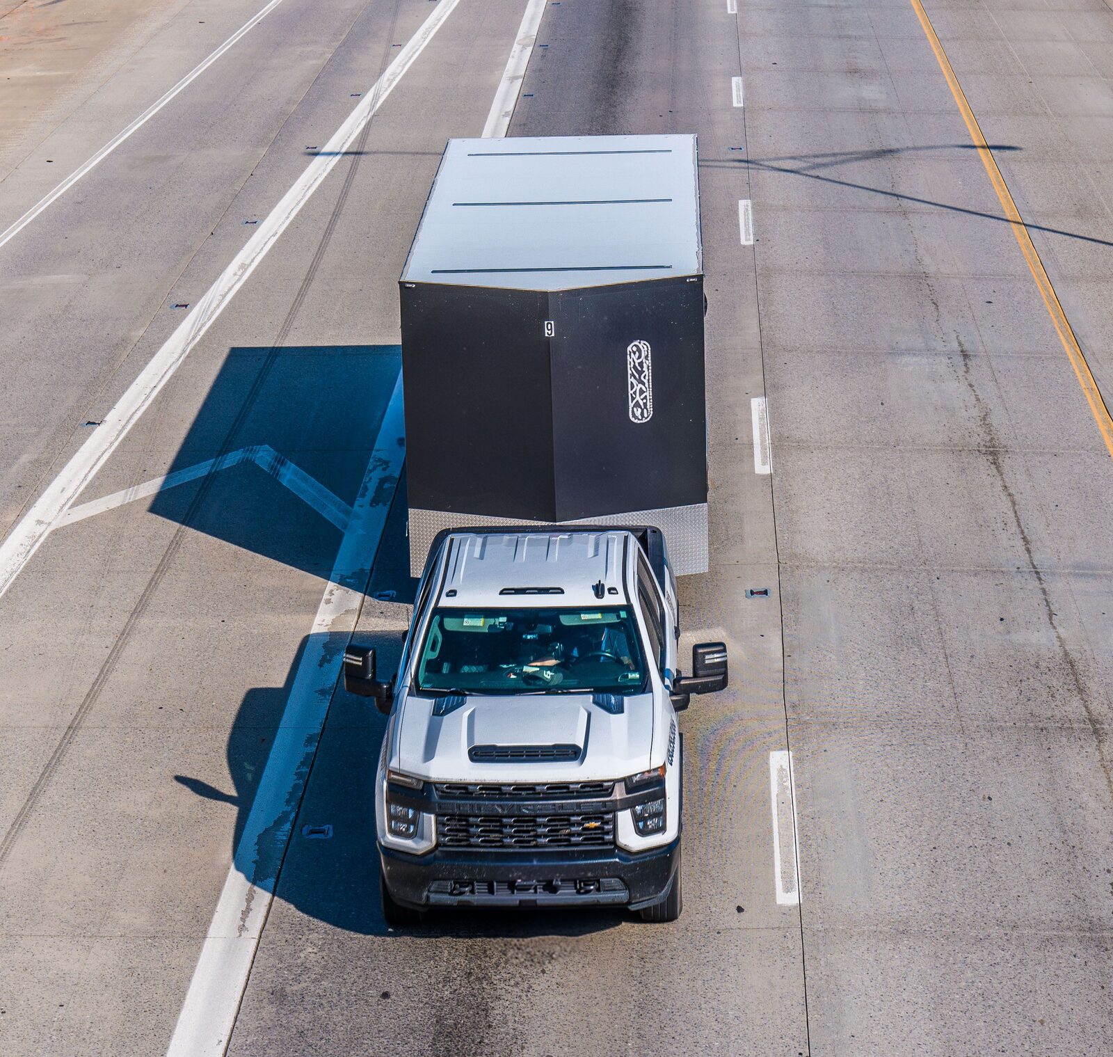 Example utility trailer hitched to a pickup truck